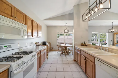 a kitchen with stainless steel appliances a sink stove and cabinets