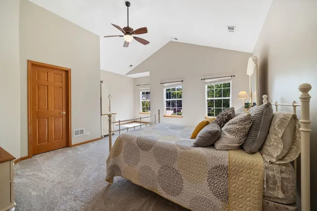 a bedroom with a large bed and a chandelier