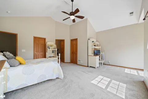 a bedroom with a bed and ceiling fan
