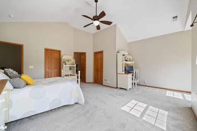 a bedroom with a bed and ceiling fan