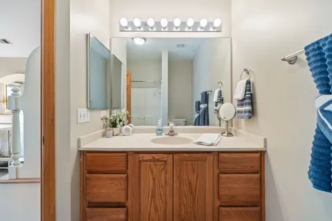 a bathroom with a double vanity sink and a mirror
