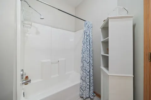 a bathroom with a bathtub and shower