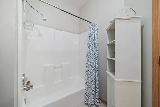 a bathroom with a bathtub and shower