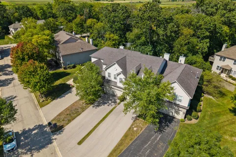 an aerial view of a house with a yard basket ball court and outdoor seating