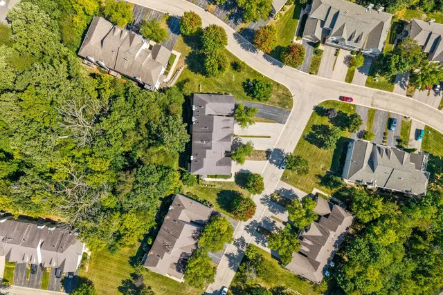 an aerial view of a house with a yard and garden