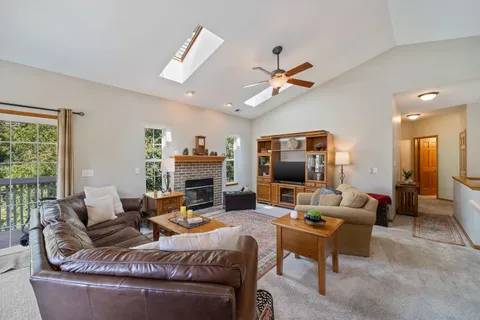 a living room with fireplace furniture and a flat screen tv