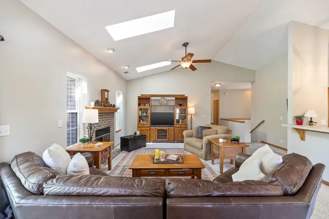 a living room with furniture and kitchen view