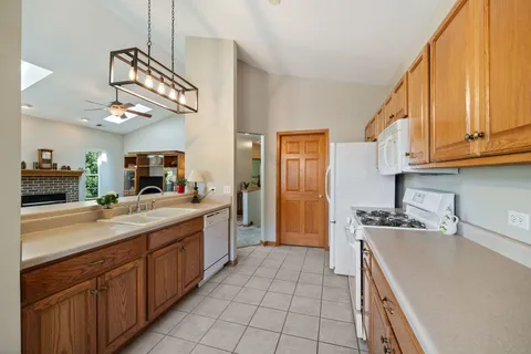 a kitchen with a sink dishwasher a stove and a microwave oven with cabinets