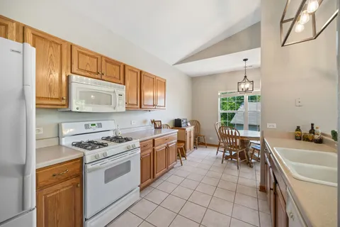 a kitchen with a sink stove top oven and microwave