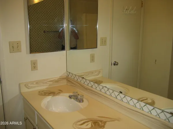 a bathroom with a sink and a mirror