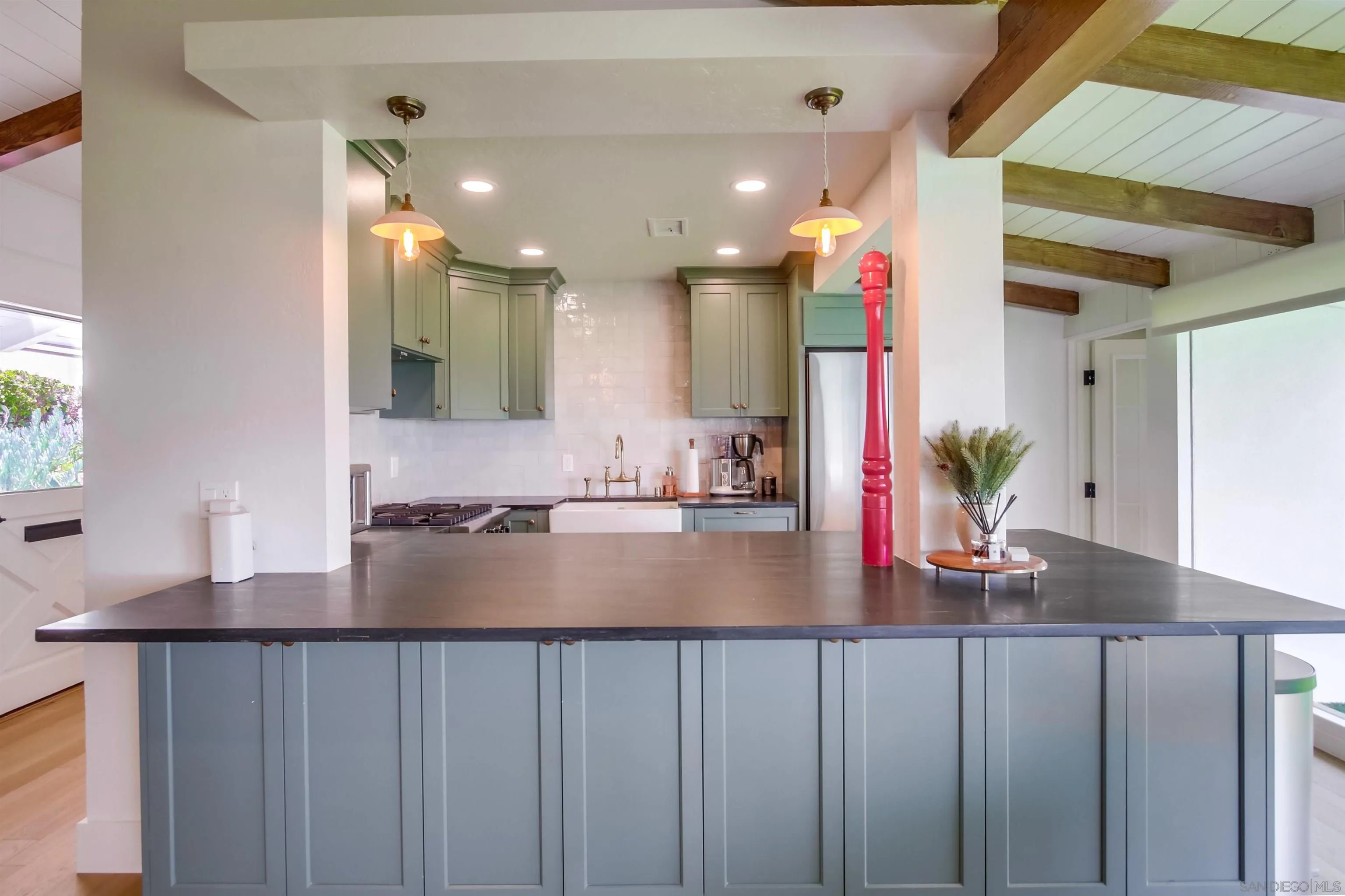 4242 Cosoy Way San Diego, CA 92110 - Photo 11 of 75 a kitchen with kitchen island granite countertop a sink cabinets and wooden floor