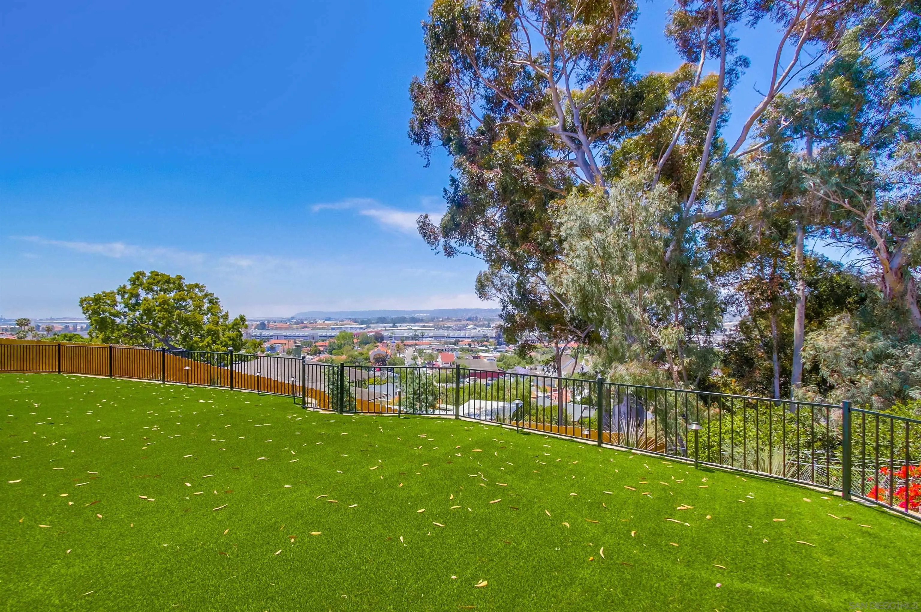 4242 Cosoy Way San Diego, CA 92110 - Photo 19 of 75 a view of a garden with a building in the background