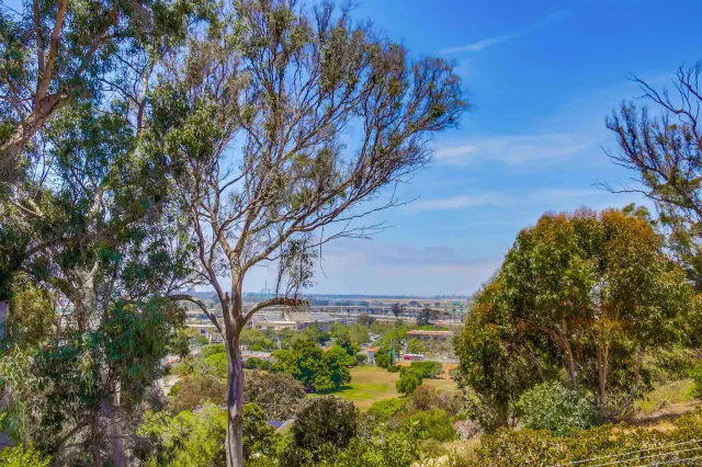 a bathroom with a granite countertop sink a toilet a shower and a mirror