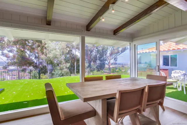 a kitchen with a table chairs and wooden floor