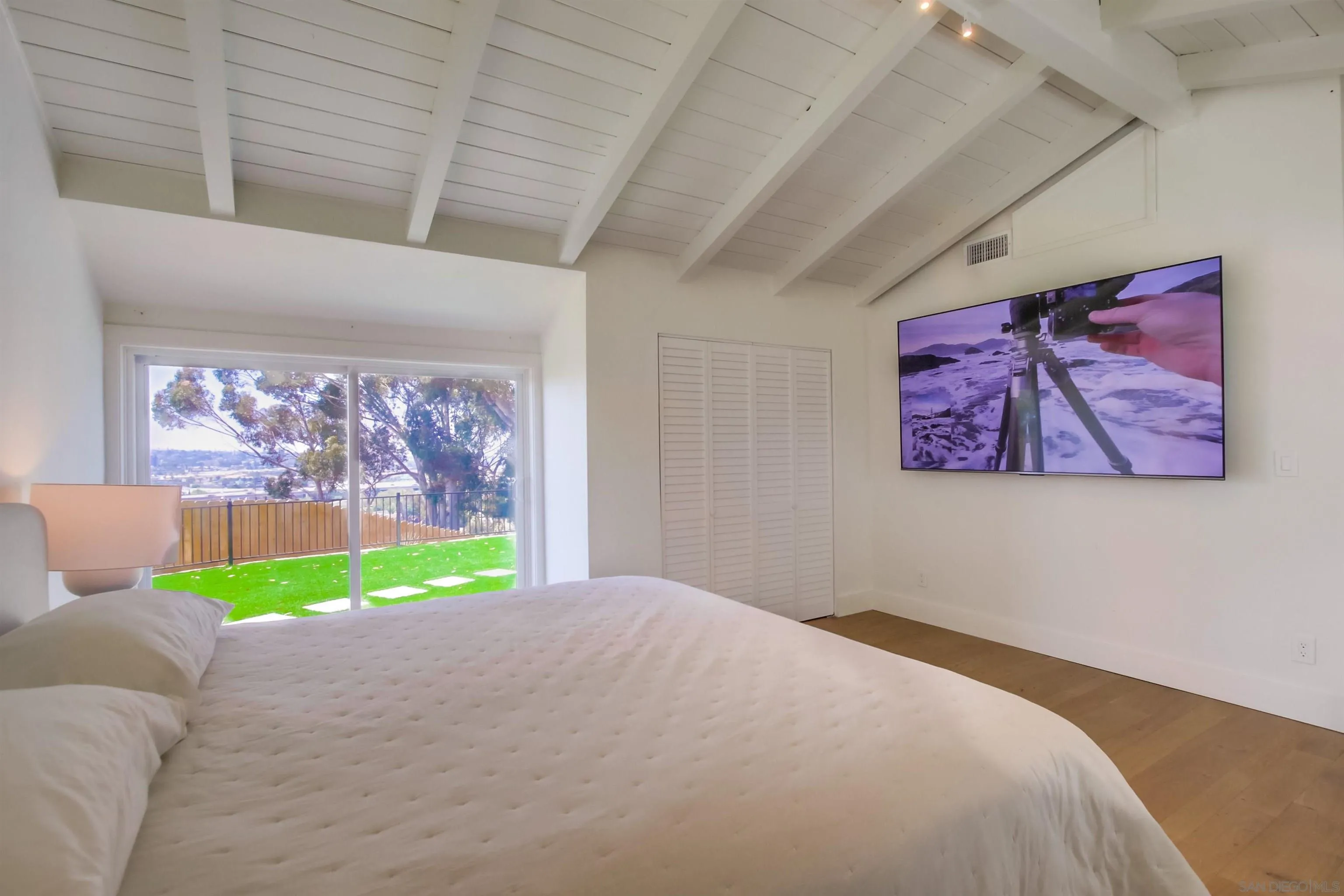 4242 Cosoy Way San Diego, CA 92110 - Photo 26 of 75 a bedroom with a bed furniture and a window