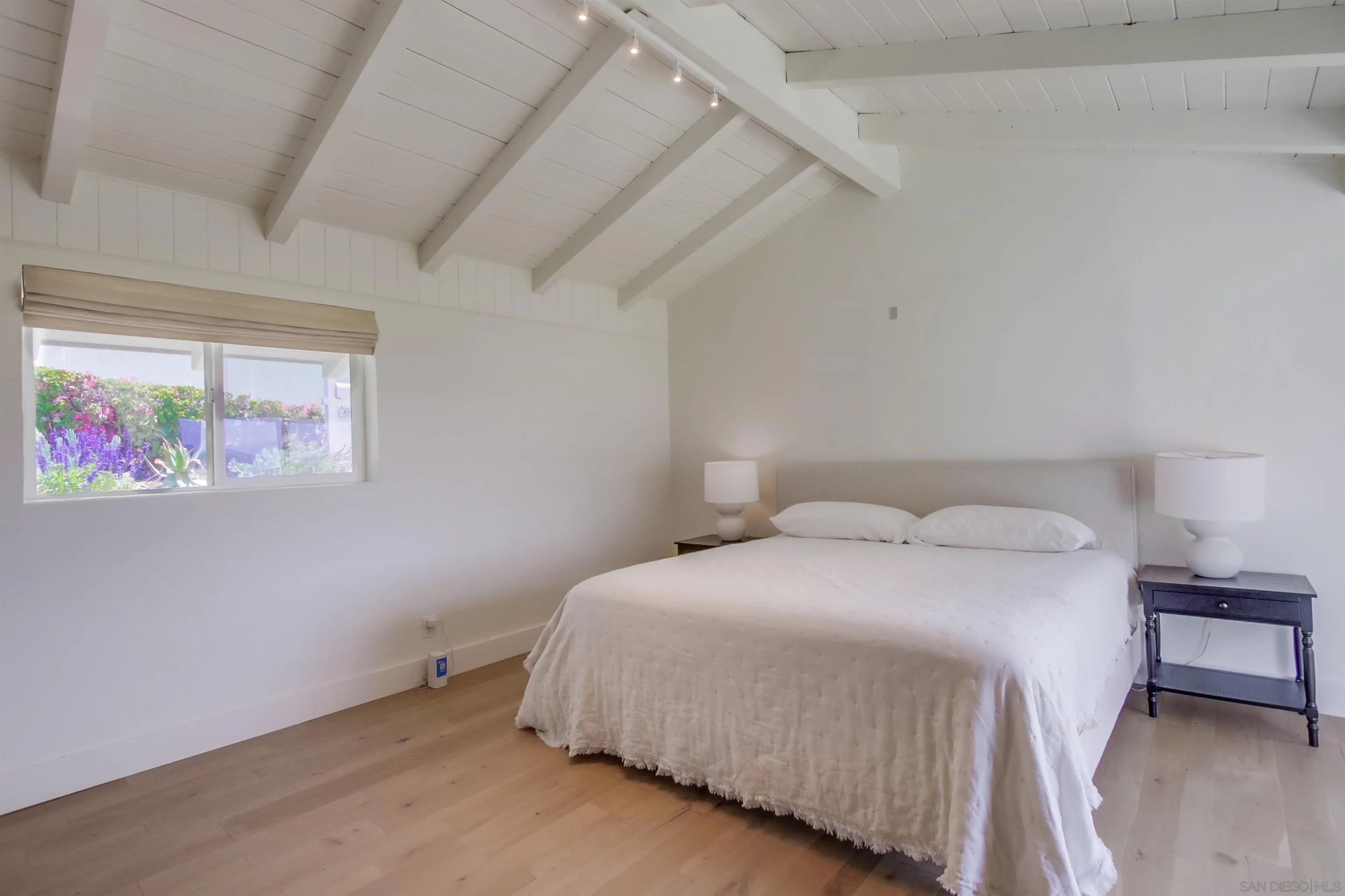 4242 Cosoy Way San Diego, CA 92110 - Photo 27 of 75 a bedroom with a bed and a window
