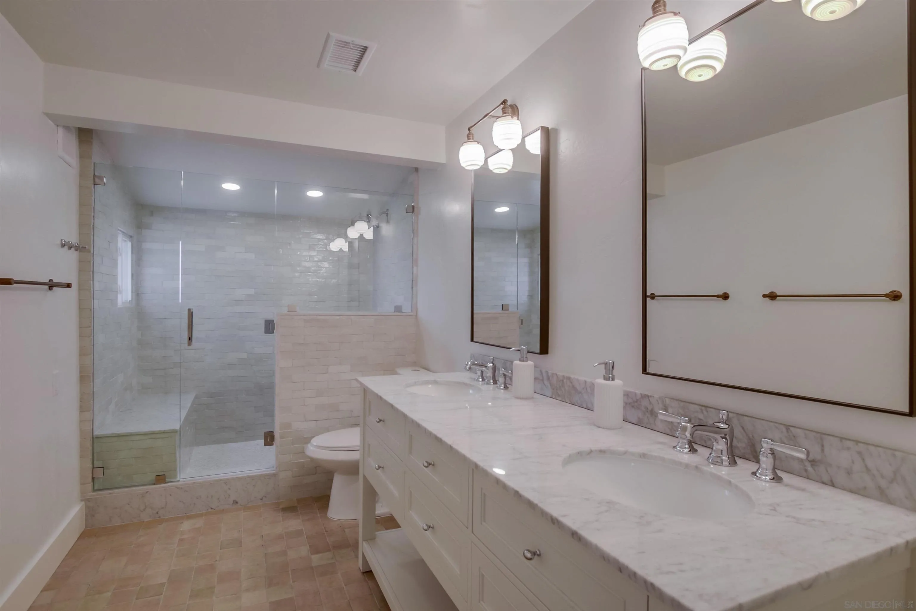 4242 Cosoy Way San Diego, CA 92110 - Photo 29 of 75 a bathroom with a granite countertop sink a toilet a shower and a mirror