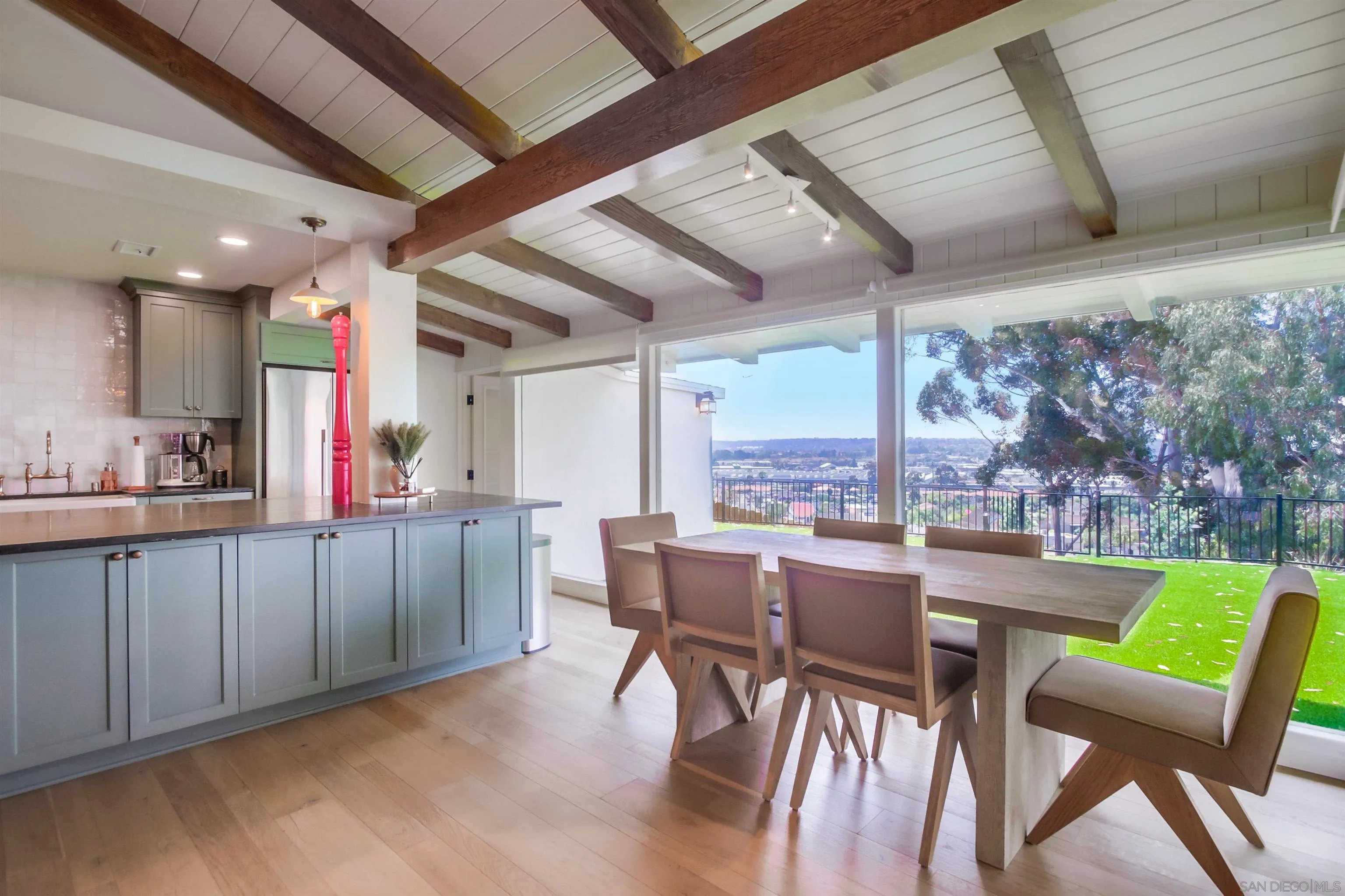 4242 Cosoy Way San Diego, CA 92110 - Photo 3 of 75 a kitchen with a table chairs and wooden floor