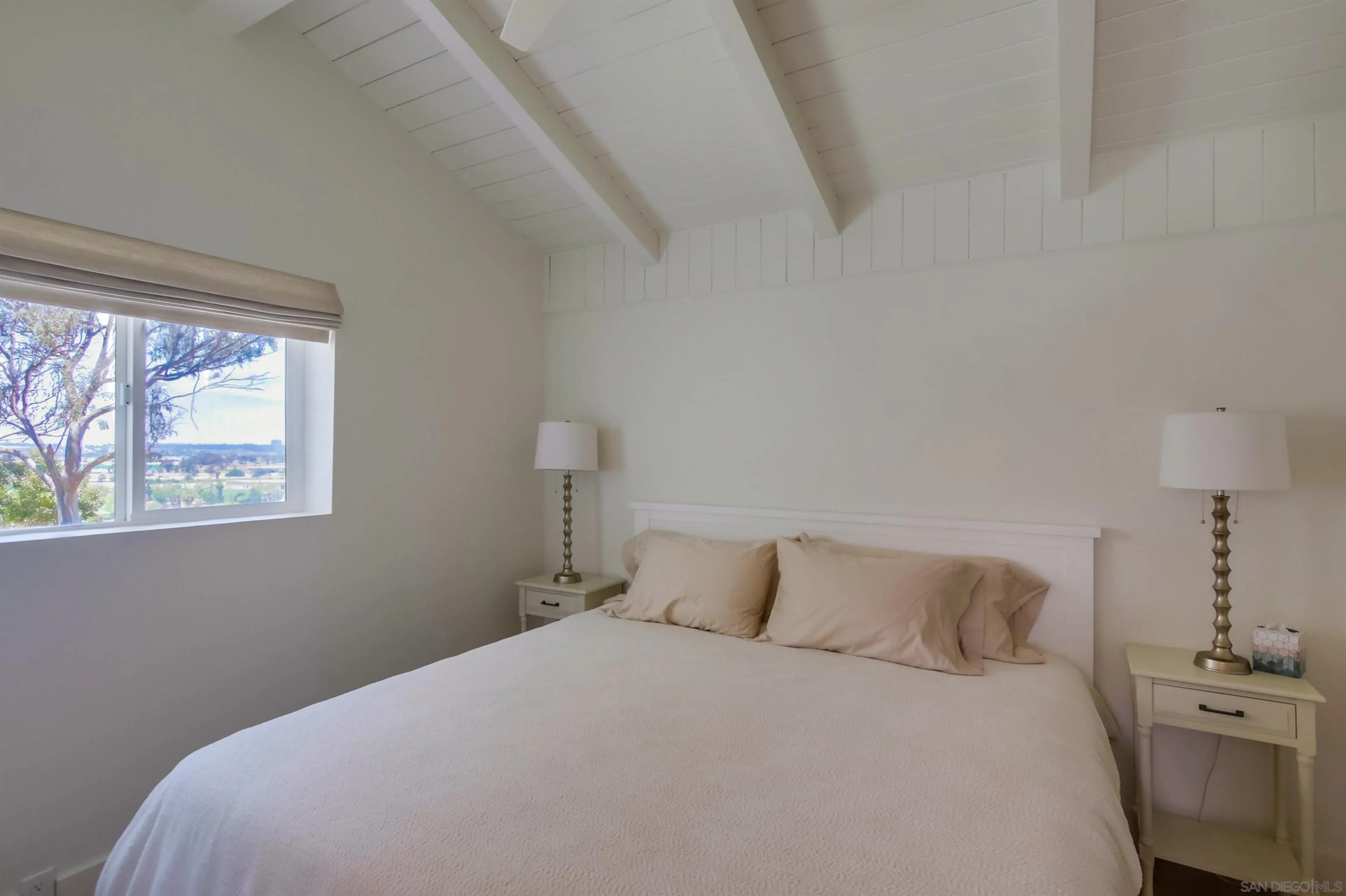 4242 Cosoy Way San Diego, CA 92110 - Photo 31 of 75 a bedroom with a bed and a window