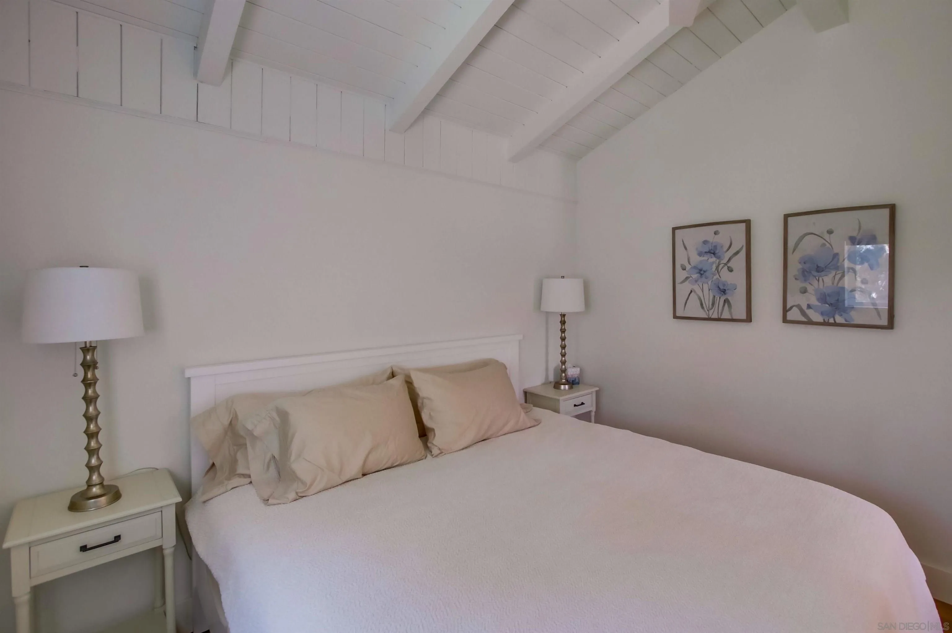 4242 Cosoy Way San Diego, CA 92110 - Photo 33 of 75 a bedroom with a bed and a lamp on the dresser