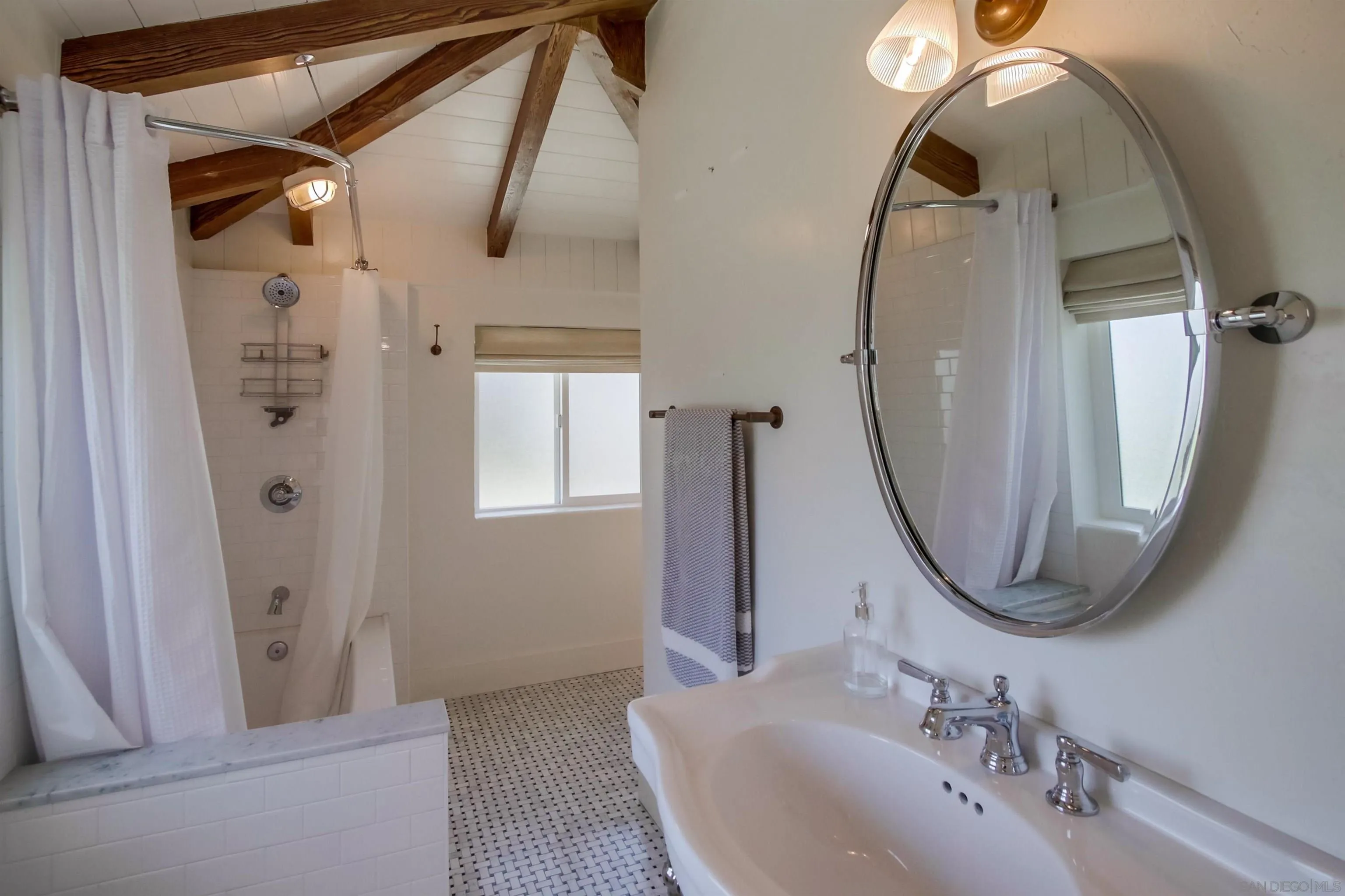 4242 Cosoy Way San Diego, CA 92110 - Photo 34 of 75 a bathroom with a sink mirror and vanity