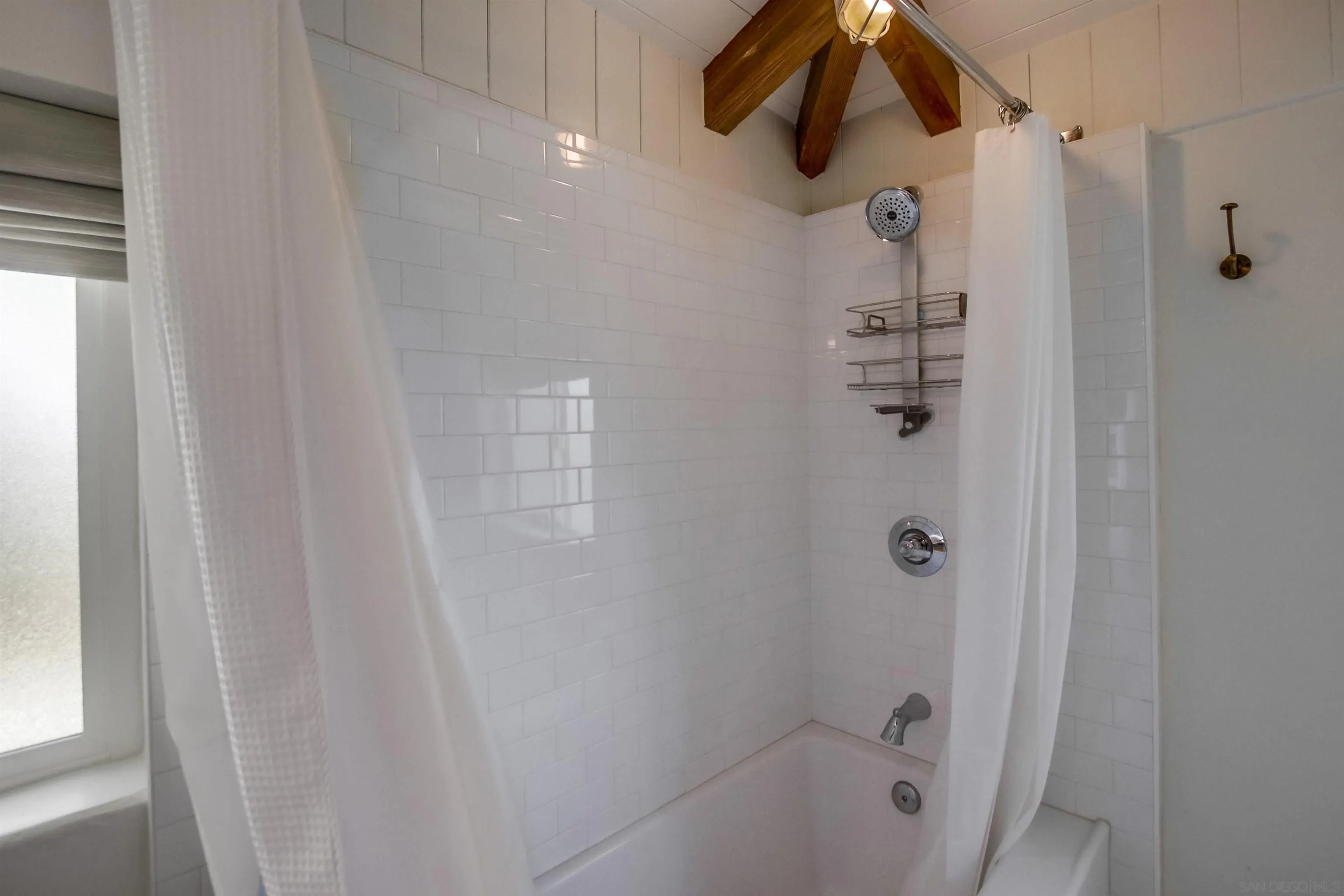 4242 Cosoy Way San Diego, CA 92110 - Photo 35 of 75 a bathroom with a shower curtain and a shower