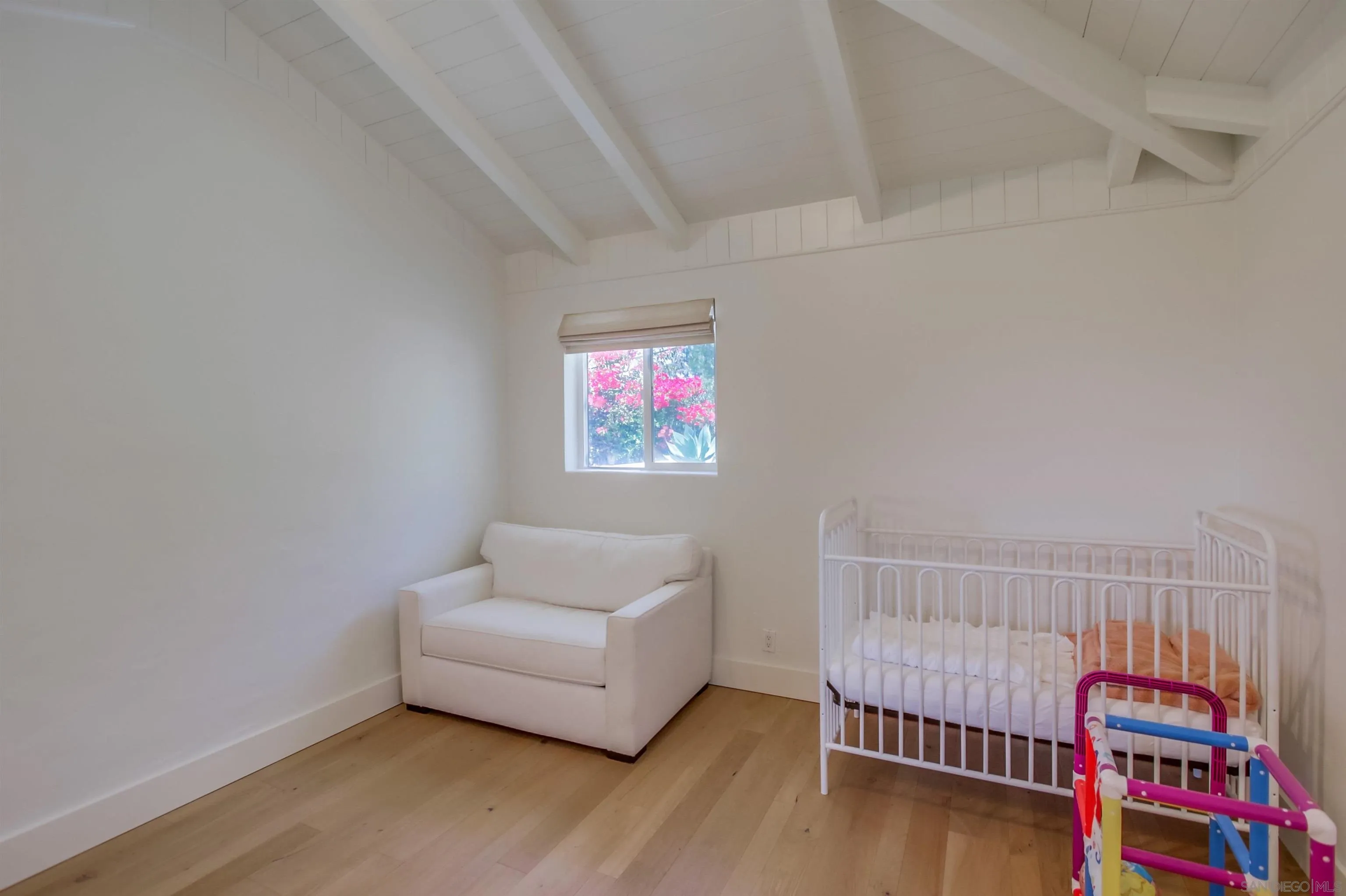 4242 Cosoy Way San Diego, CA 92110 - Photo 40 of 75 a room with baby crib and furniture