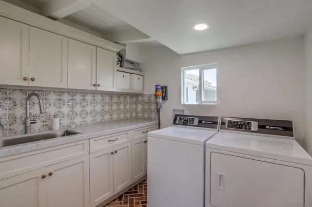 an aerial view of a house with a yard and lake view in back