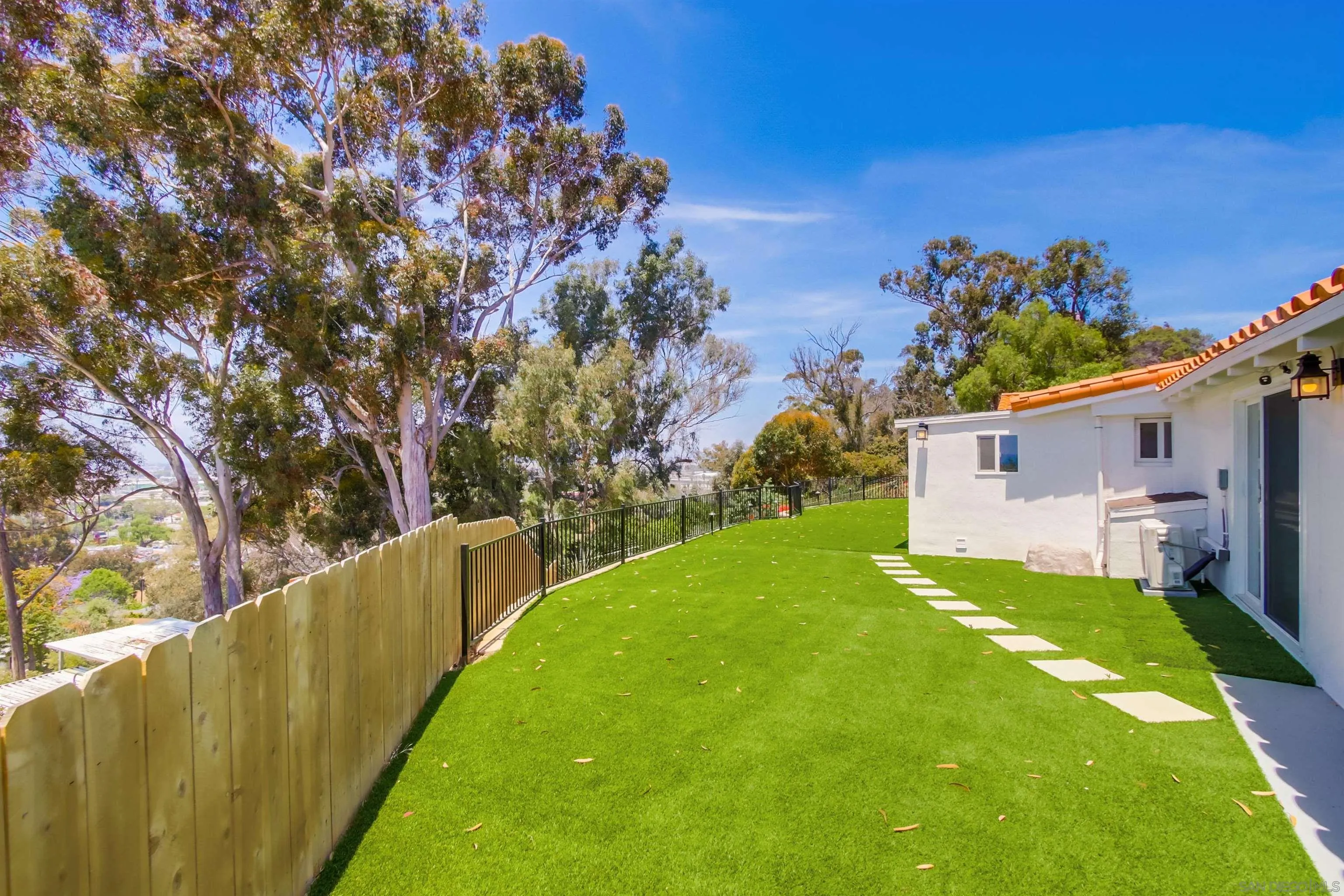 4242 Cosoy Way San Diego, CA 92110 - Photo 45 of 75 a view of a house with a backyard