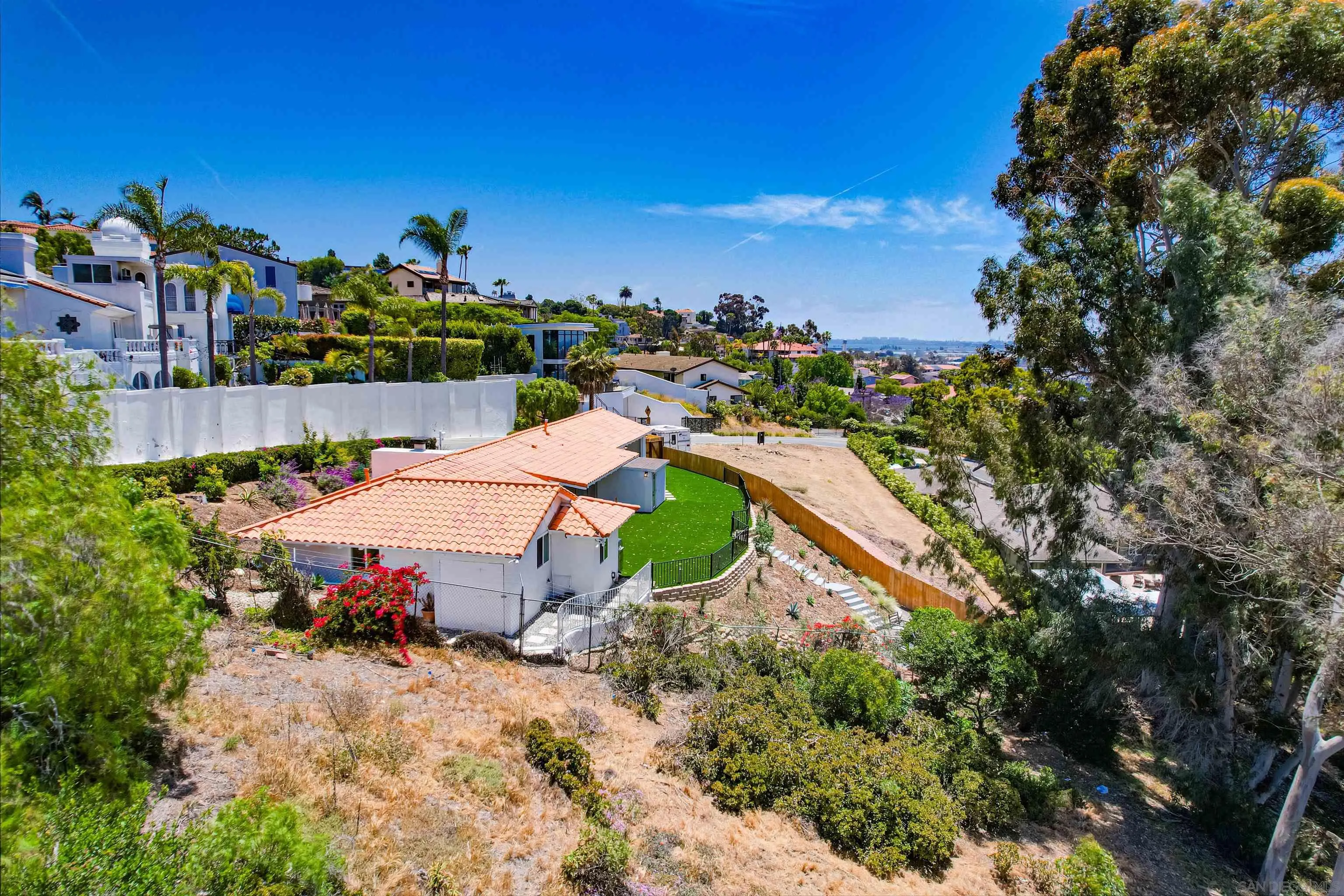 4242 Cosoy Way San Diego, CA 92110 - Photo 55 of 75 a view of a house with a yard