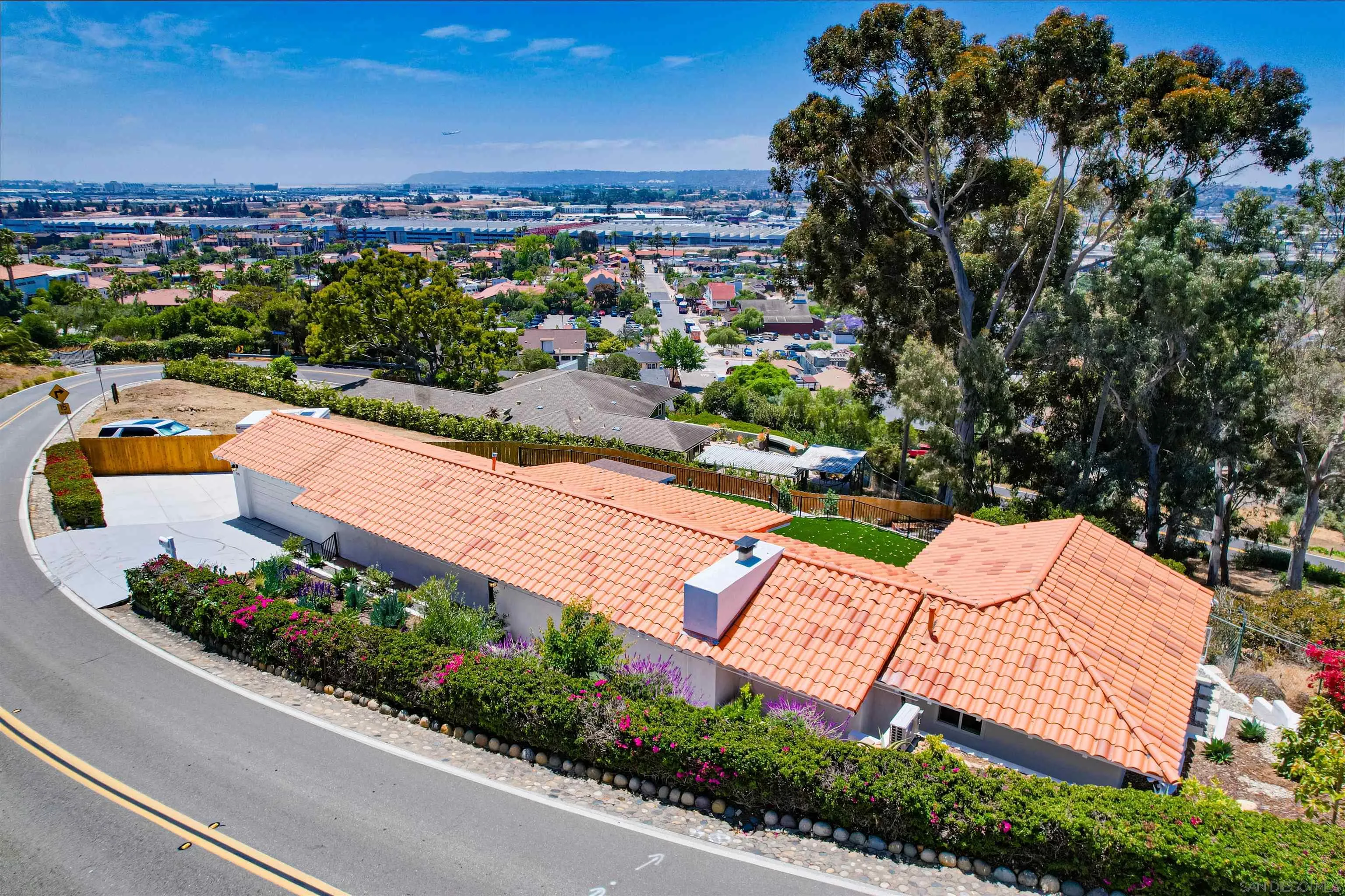 4242 Cosoy Way San Diego, CA 92110 - Photo 61 of 75 an aerial view of a house with a yard and lake view in back