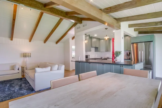 a kitchen with kitchen island granite countertop a sink cabinets and wooden floor