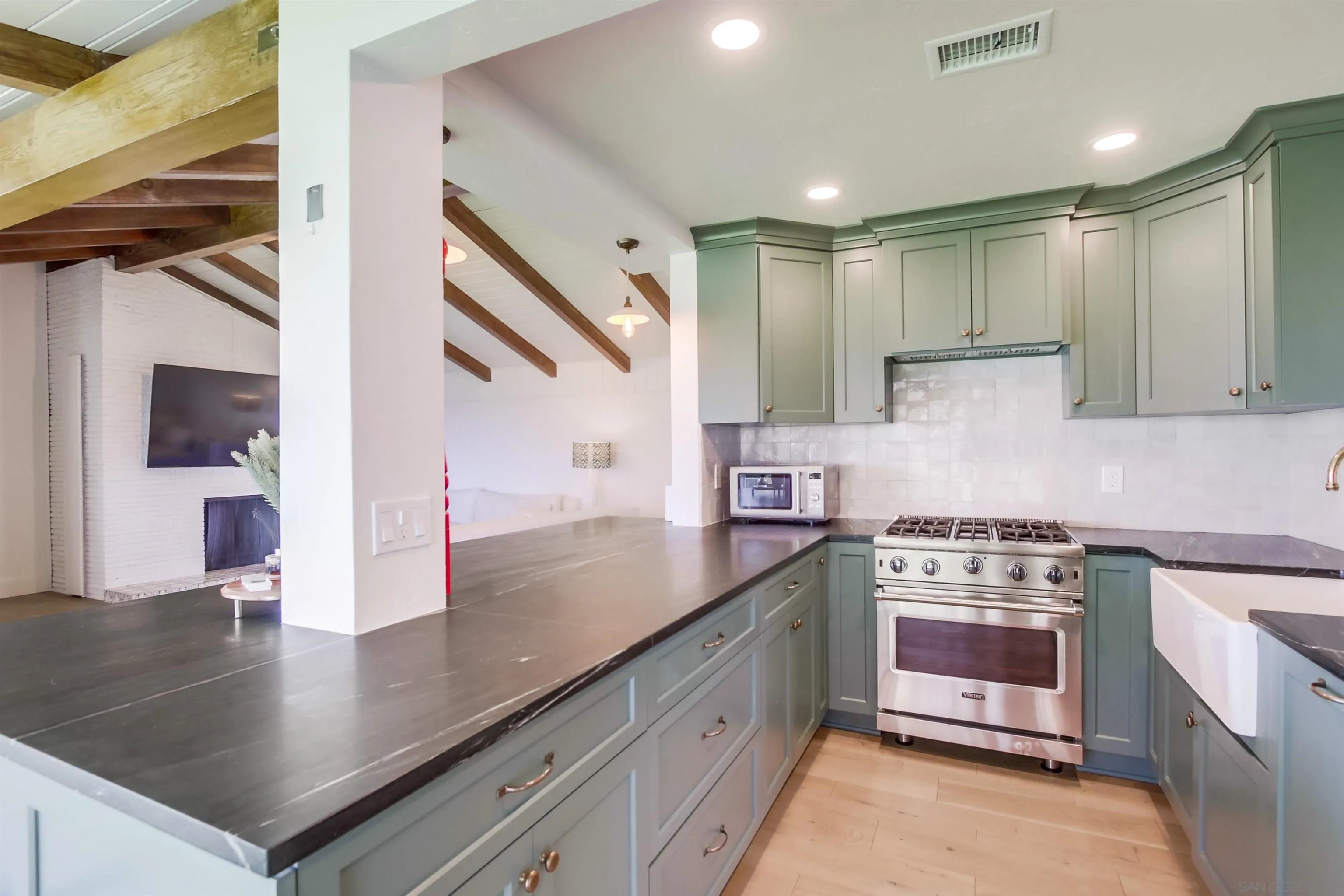 4242 Cosoy Way San Diego, CA 92110 - Photo 10 of 75 a kitchen with stainless steel appliances granite countertop a sink a stove and a wooden cabinets