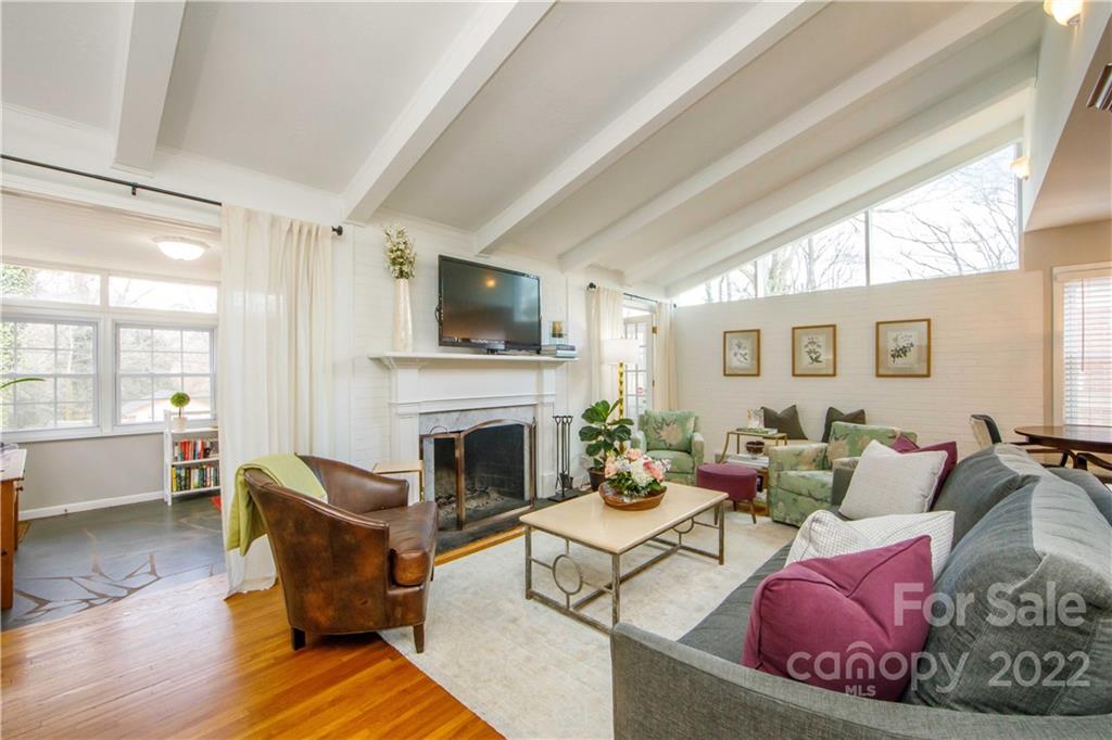5539 Murrayhill Road Charlotte, NC 28210 - Photo 12 of 46 a living room with furniture a flat screen tv and a fireplace