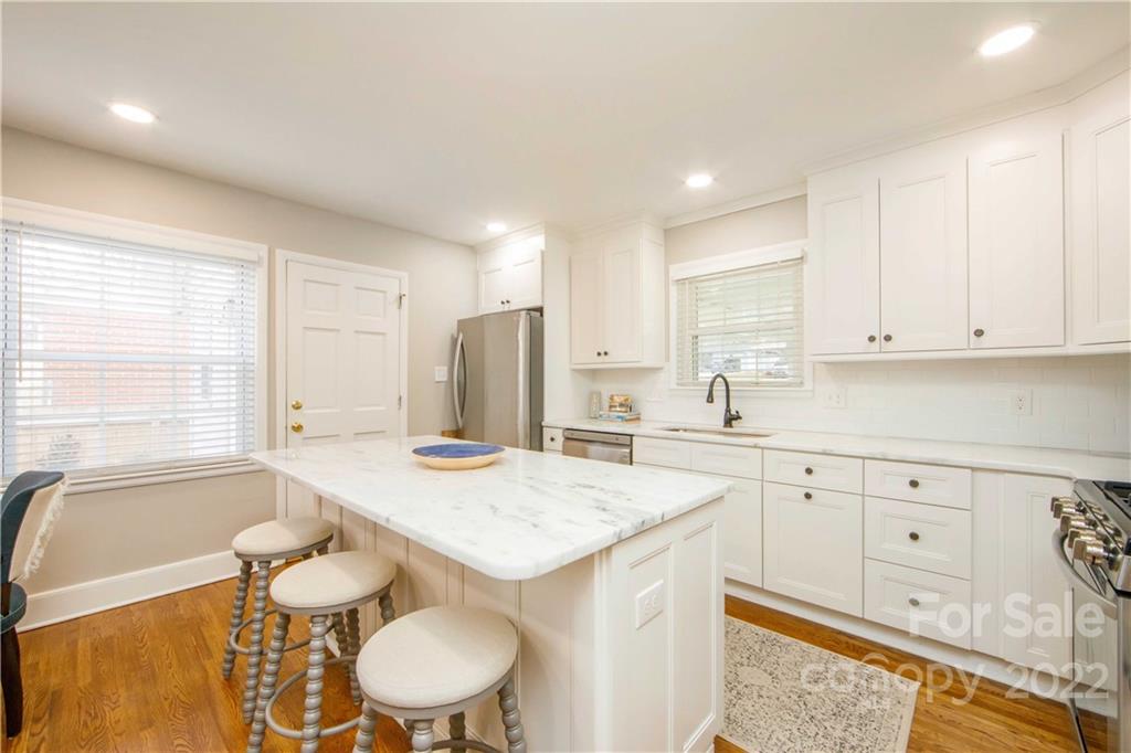 5539 Murrayhill Road Charlotte, NC 28210 - Photo 17 of 46 a open kitchen with stainless steel appliances granite countertop a sink a stove a dining table and chairs