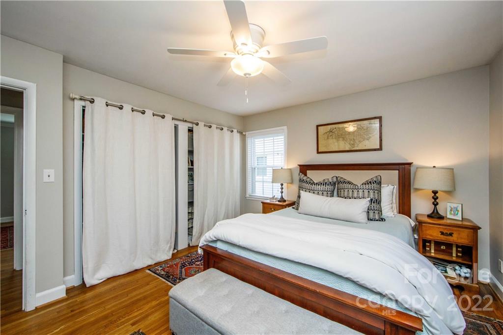 5539 Murrayhill Road Charlotte, NC 28210 - Photo 35 of 46 a bedroom with a large bed and a chandelier