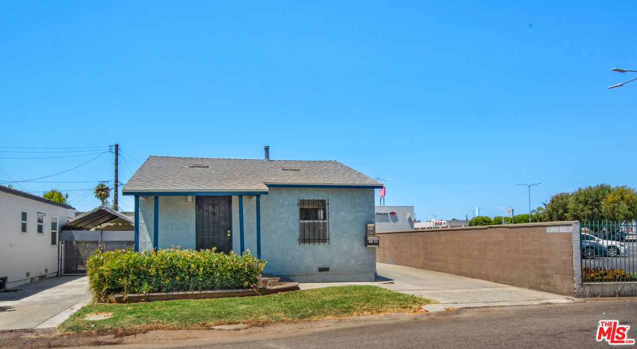 521 South Bullis Road Compton, CA 90221 - Photo 2 of 16 a front view of a house with a garden