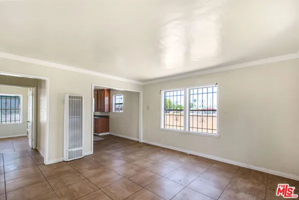 an empty room with windows and closet