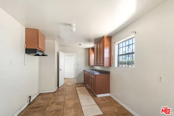 a room with furniture a flat screen tv and a window