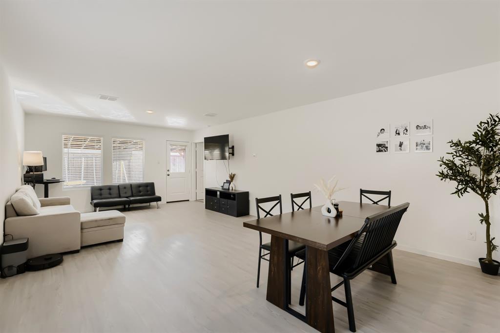 1619 Grassy Pond Road Forney, TX 75126 - Photo 15 of 28 Open-concept living space featuring light-toned wood-finish flooring, recessed lighting, and white walls