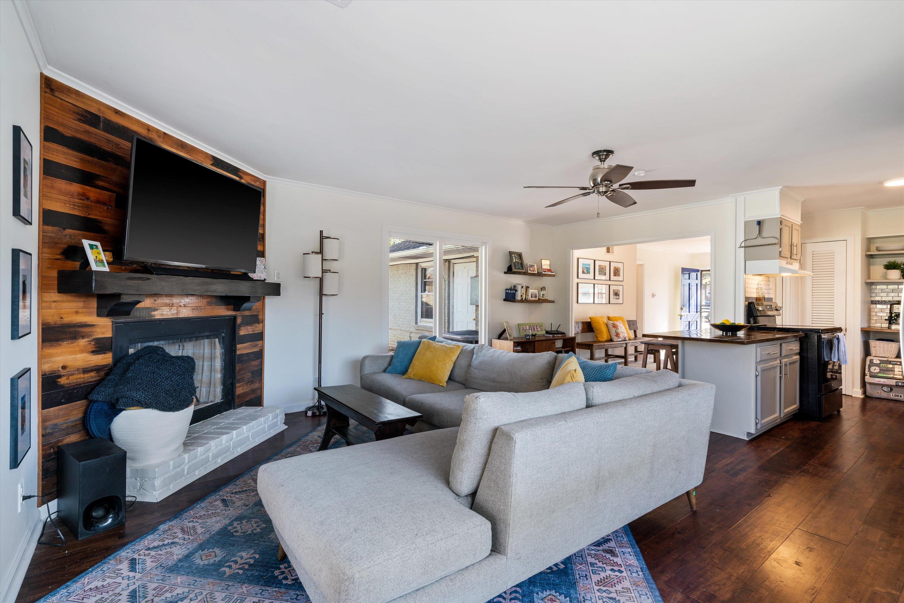 1081 Wilbec Road Memphis, TN 38117 - Photo 5 of 18 a living room with furniture a flat screen tv and a fireplace