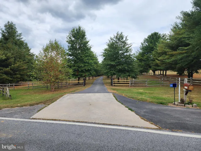 a view of a wooden bench with a bench in the yard