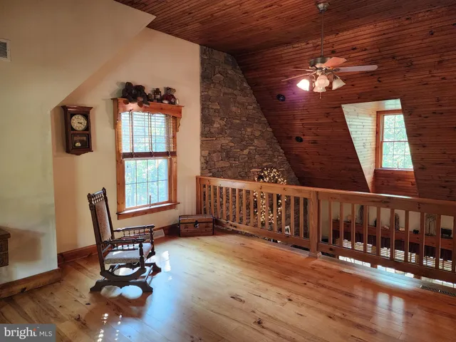 a bedroom with a bed a dresser and chair