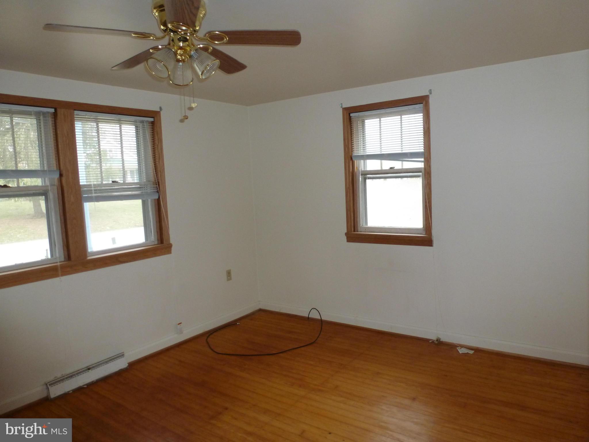 10321 Bethel Road Frederick, MD 21702 - Photo 11 of 18 a view of an empty room with wooden floor and window