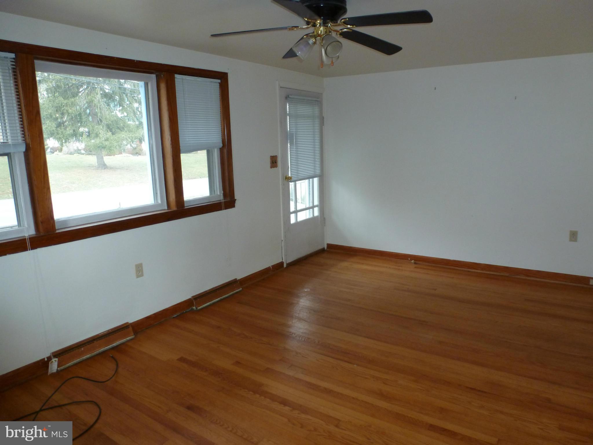 10321 Bethel Road Frederick, MD 21702 - Photo 8 of 18 a view of an empty room with wooden floor and a window