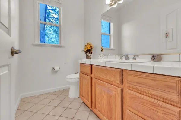a bathroom with a sink a toilet and a mirror