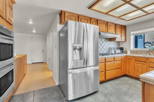 a kitchen with stainless steel appliances a refrigerator and a stove