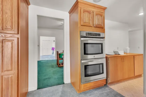 a kitchen with granite countertop cabinets stainless steel appliances and wooden floor