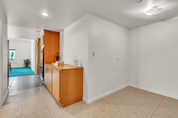 a view of a hallway with wooden floor and a sink