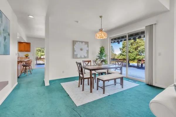 a view of a dining room with furniture window and outside view